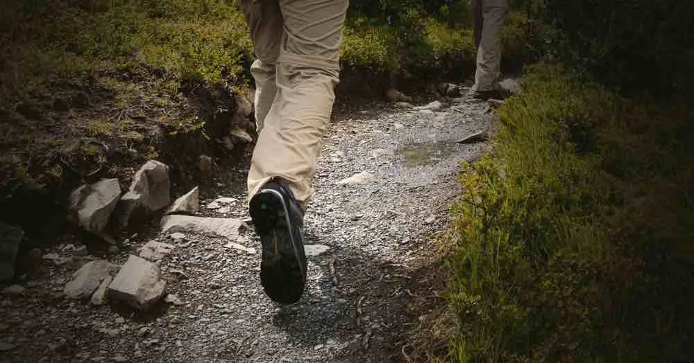 Walking boots on a gravel path between green verges